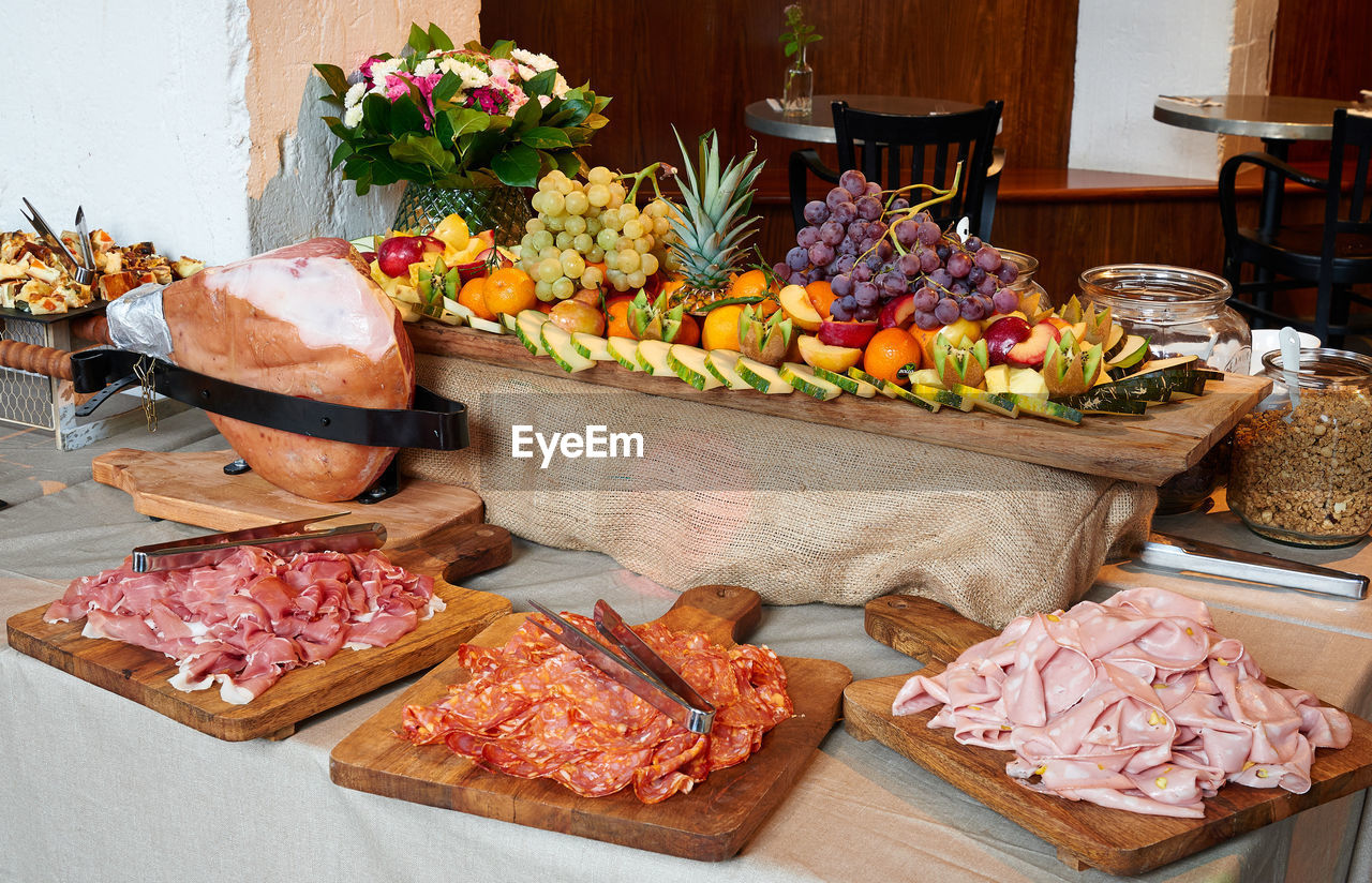 Colored buffet with seasonal fresh fruits and different kind of ham