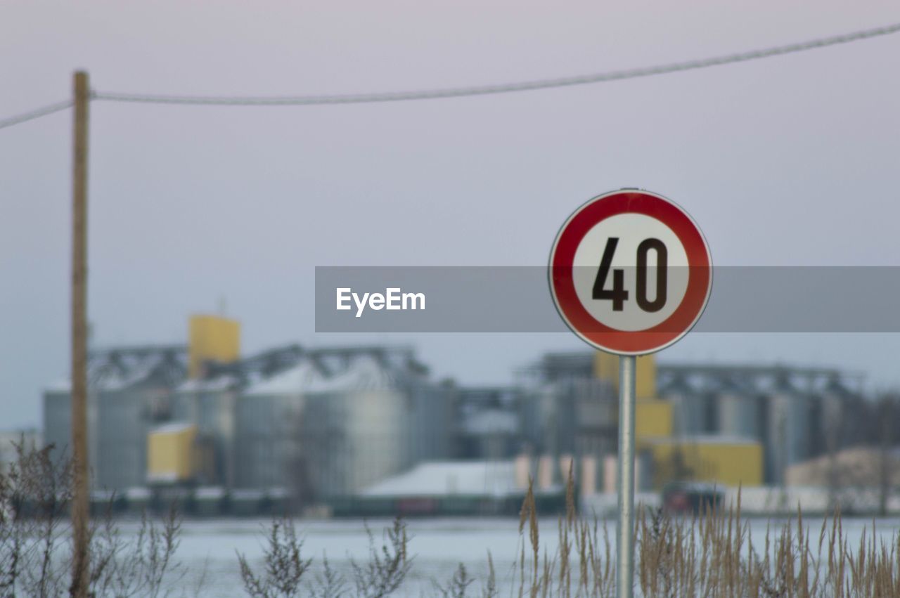Speed limit sign against factory