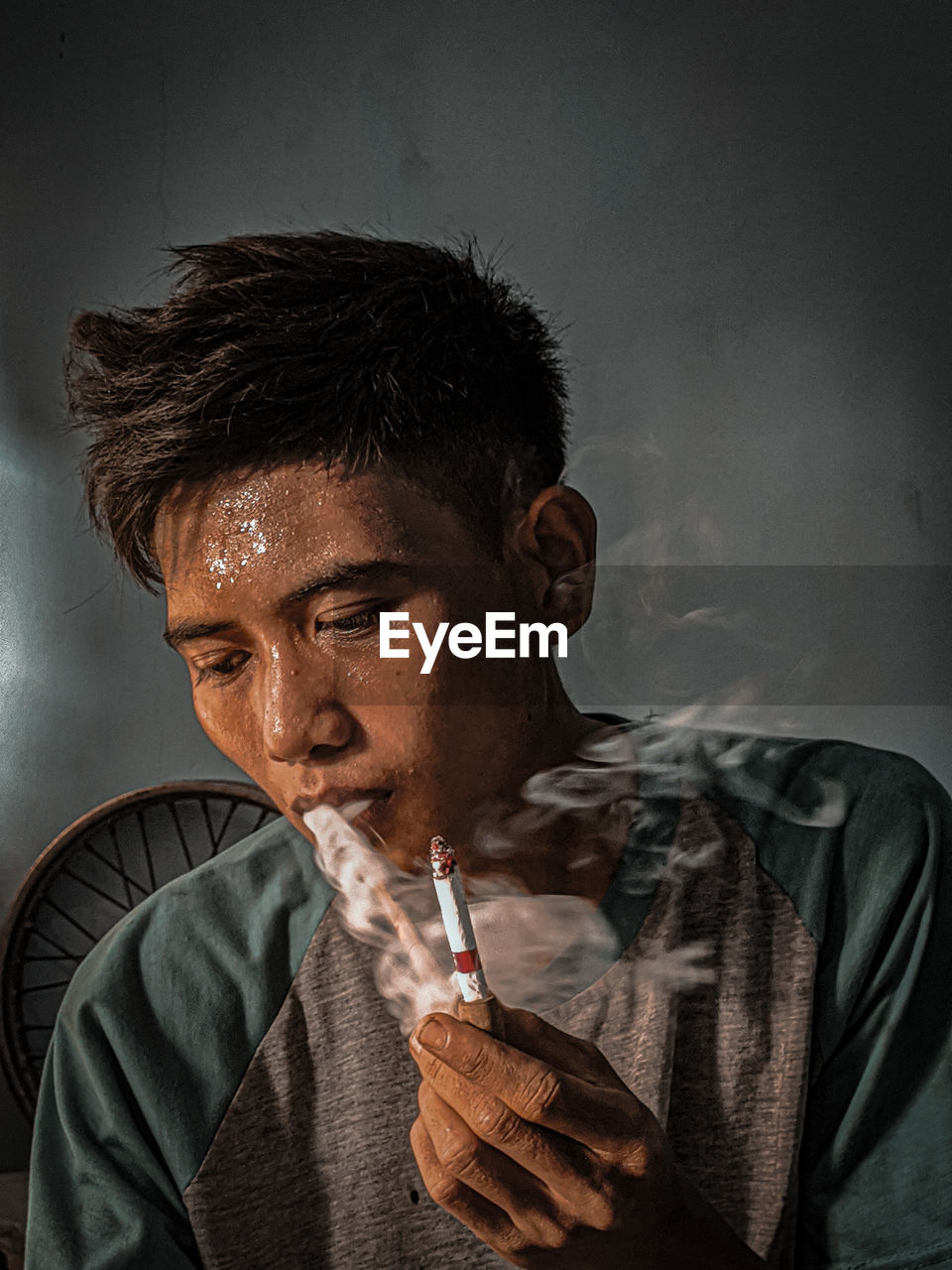 PORTRAIT OF YOUNG MAN SMOKING