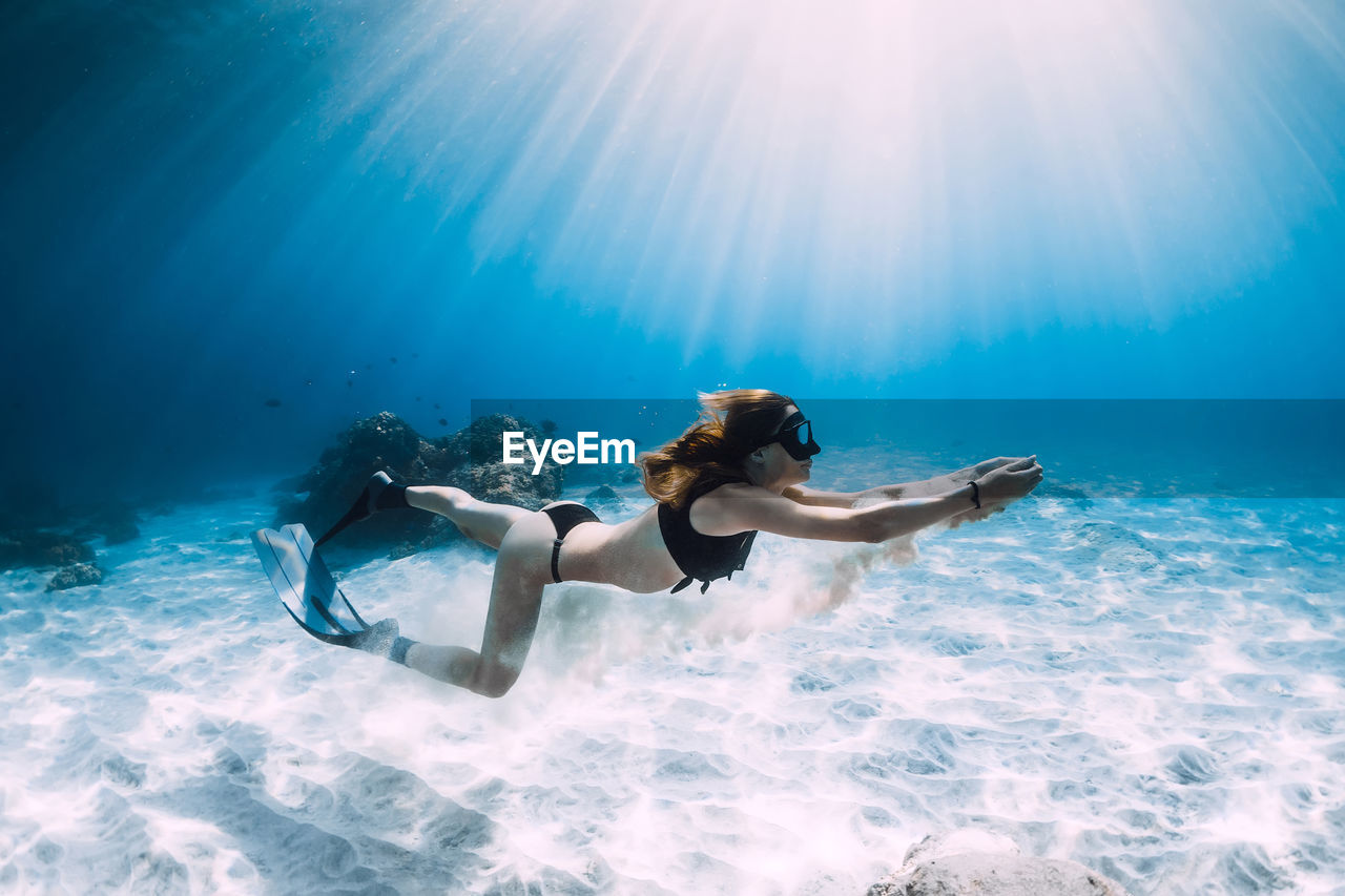 rear view of woman swimming in sea