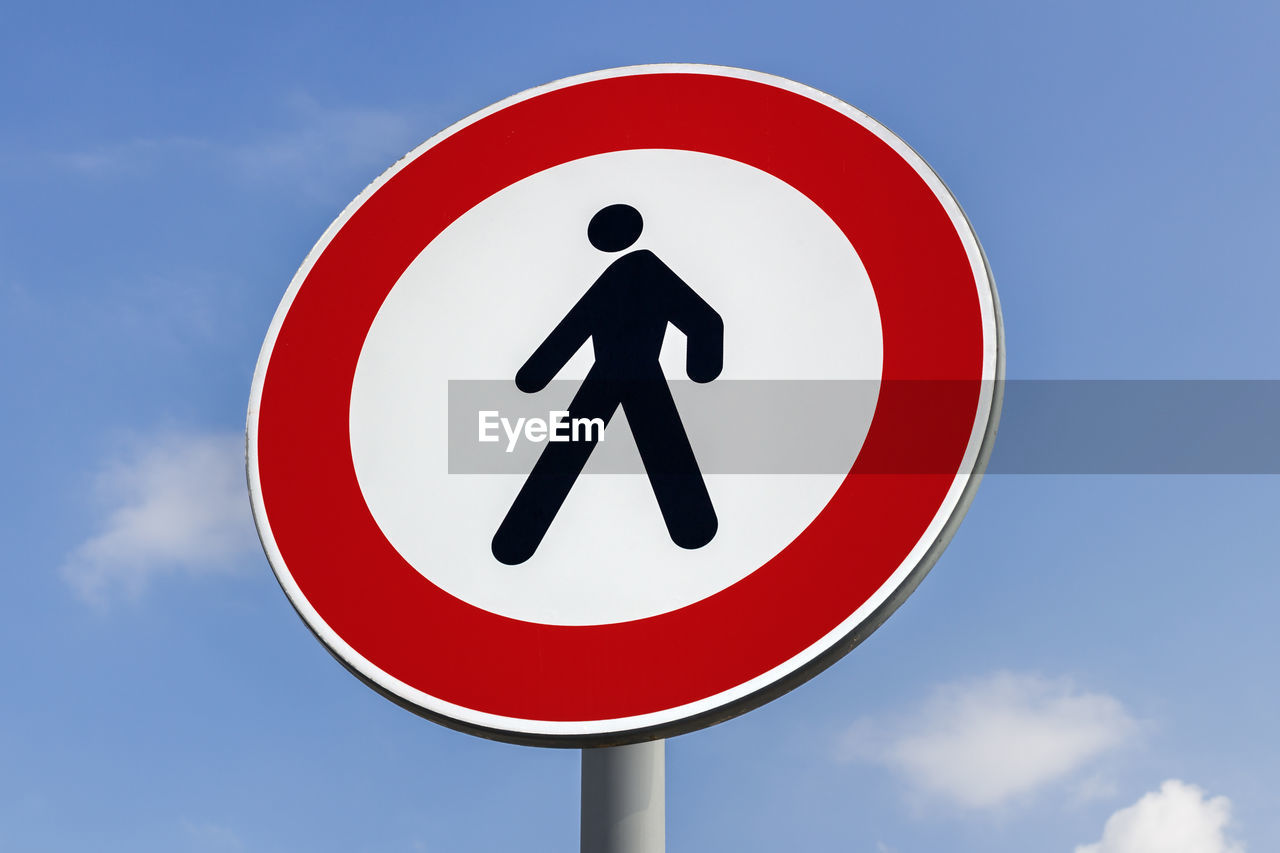 Low angle view of road sign against sky