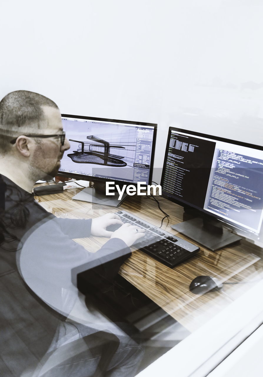 MAN WORKING ON TABLE AT HOME