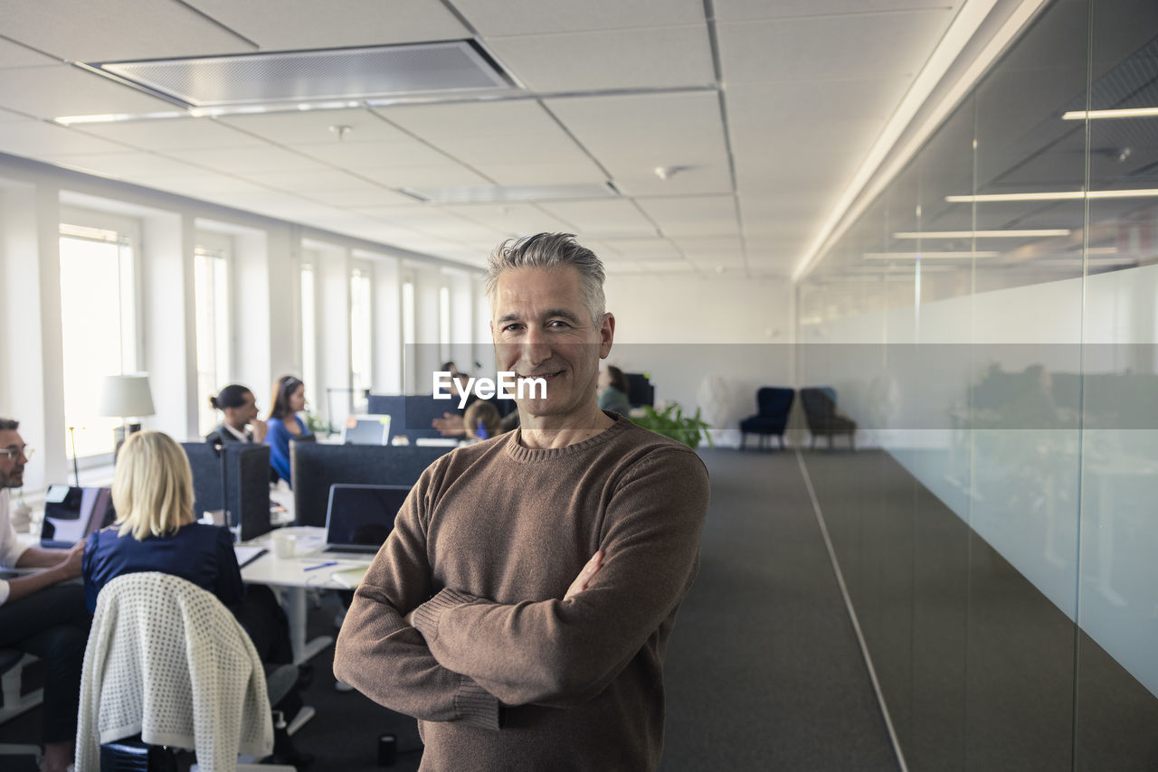 Portrait of team leader standing in office