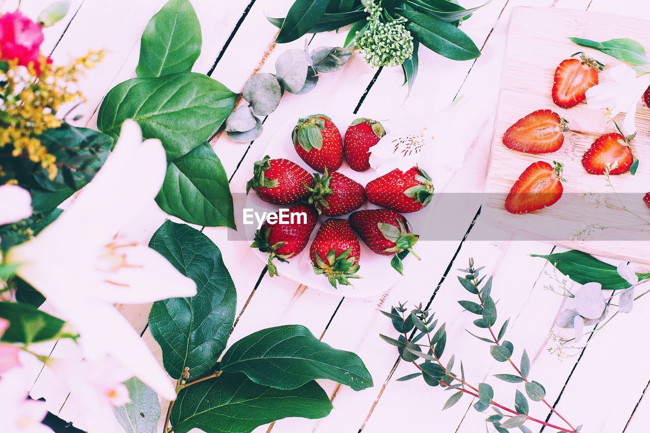 High angle view of strawberries and flowers