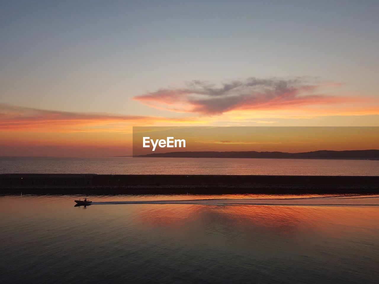 Scenic view of sea against sky during sunset