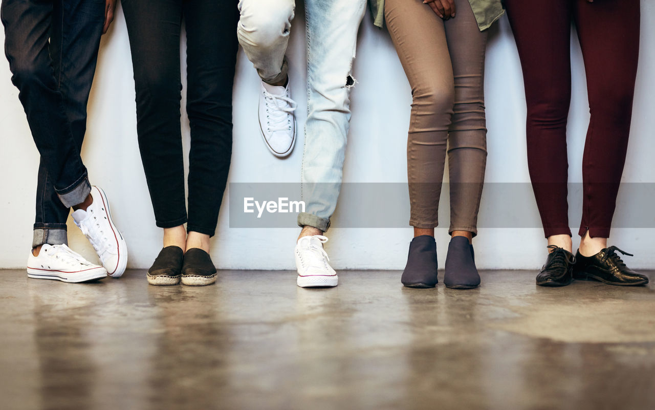 low section of people walking on hardwood floor