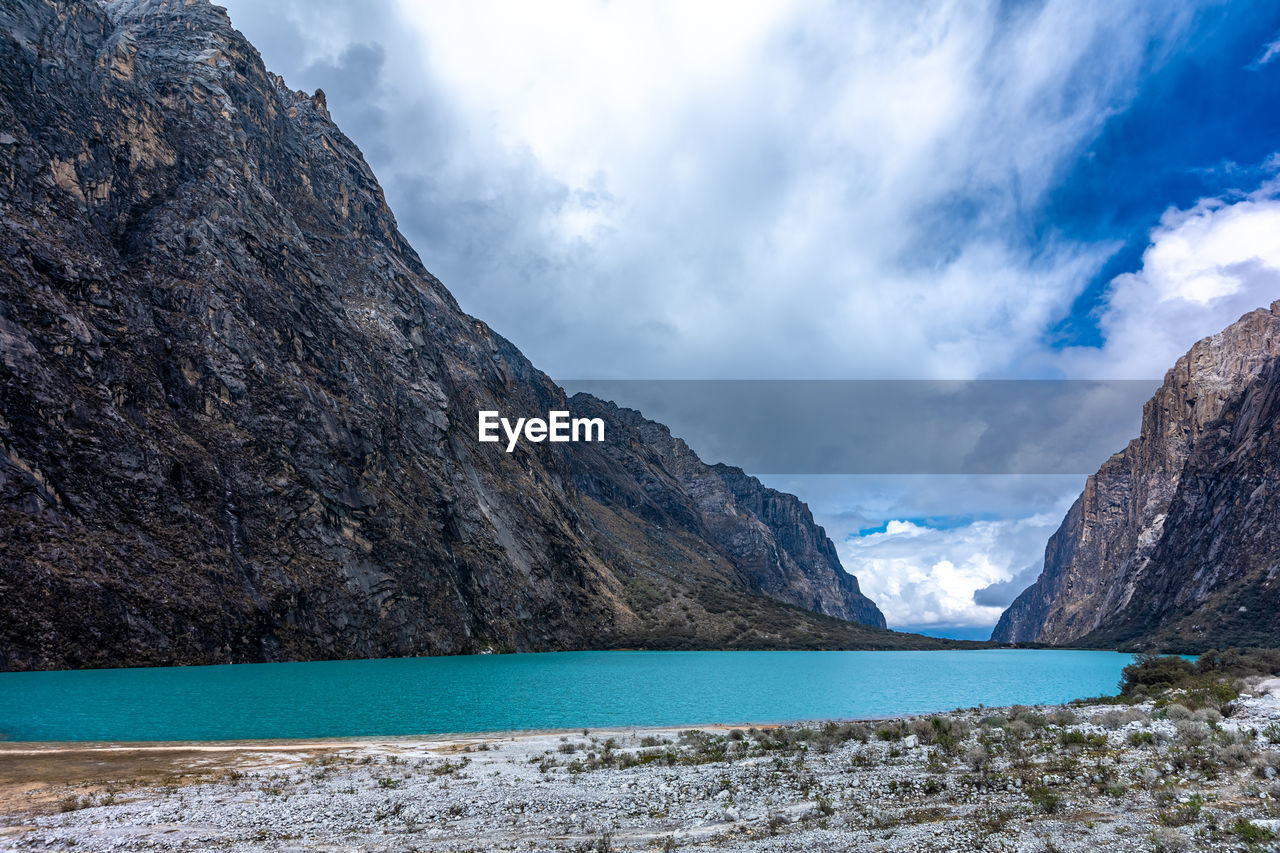 scenic view of sea and mountains against sky