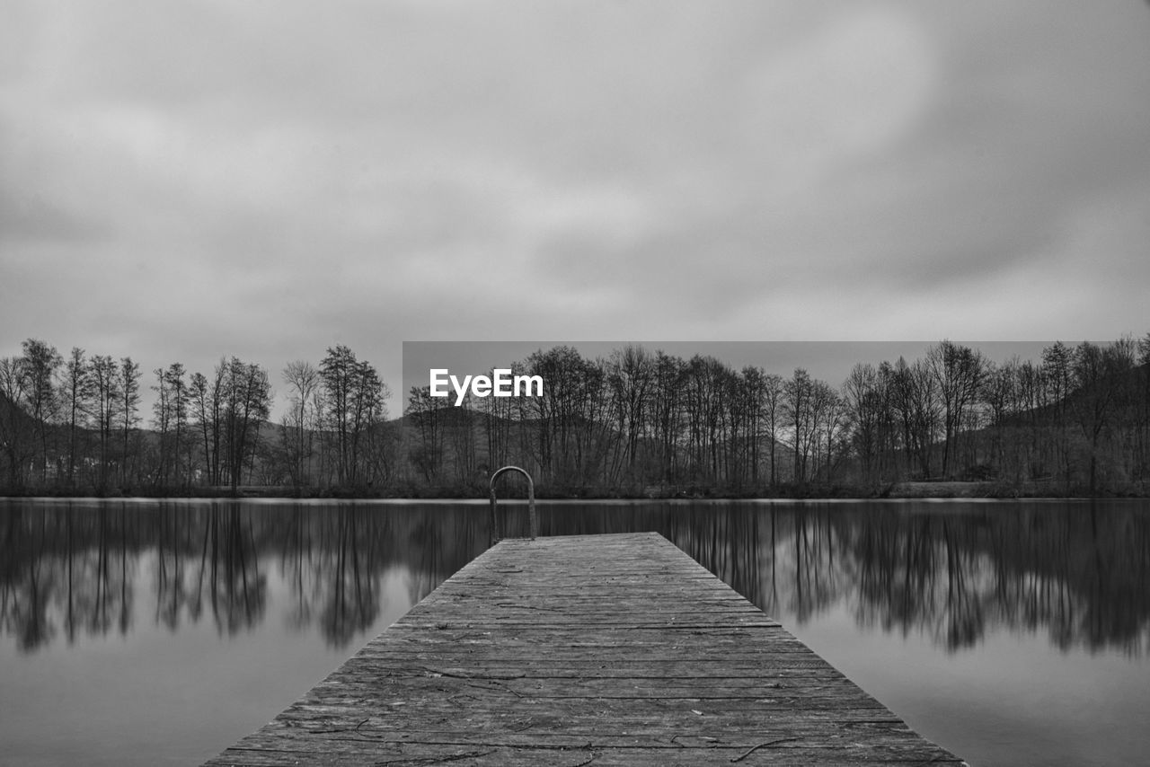 Pier over lake against sky