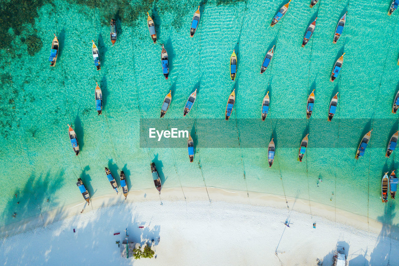 HIGH ANGLE VIEW OF PEOPLE AT SWIMMING POOL