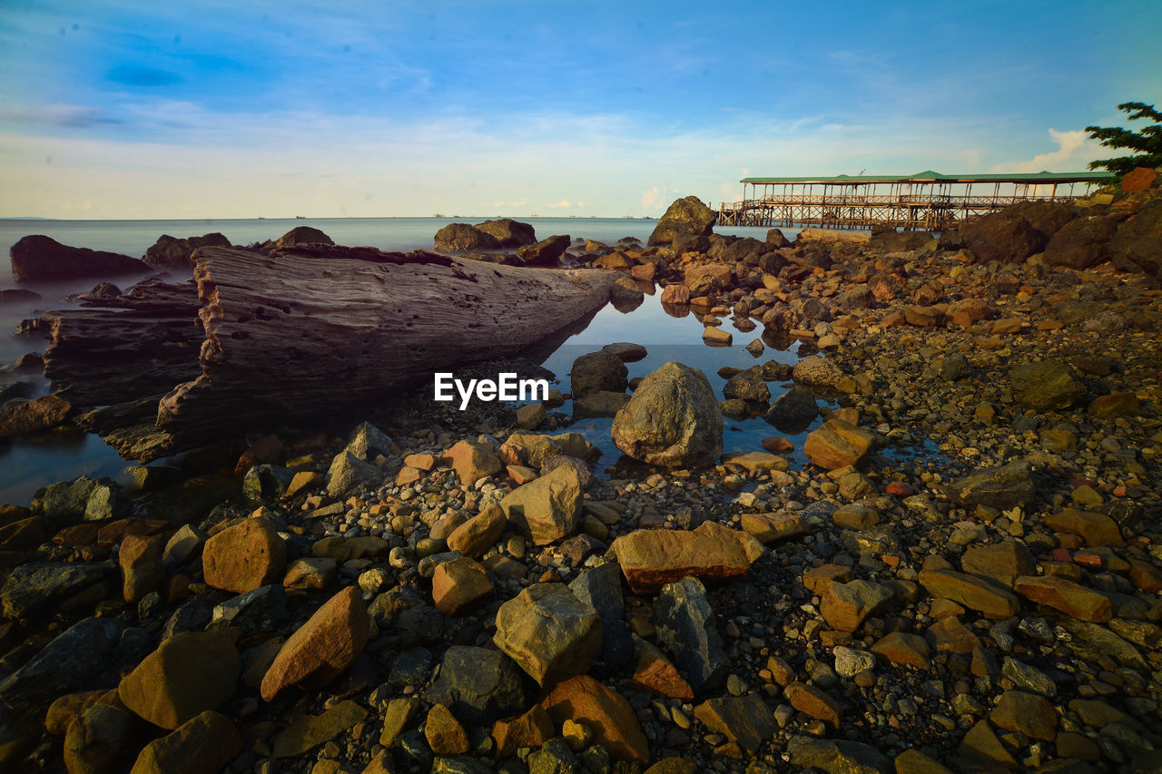 Rocks in sea against sky