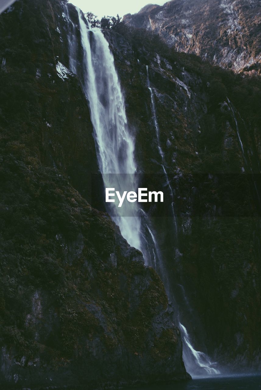 VIEW OF WATERFALL WITH STREAM