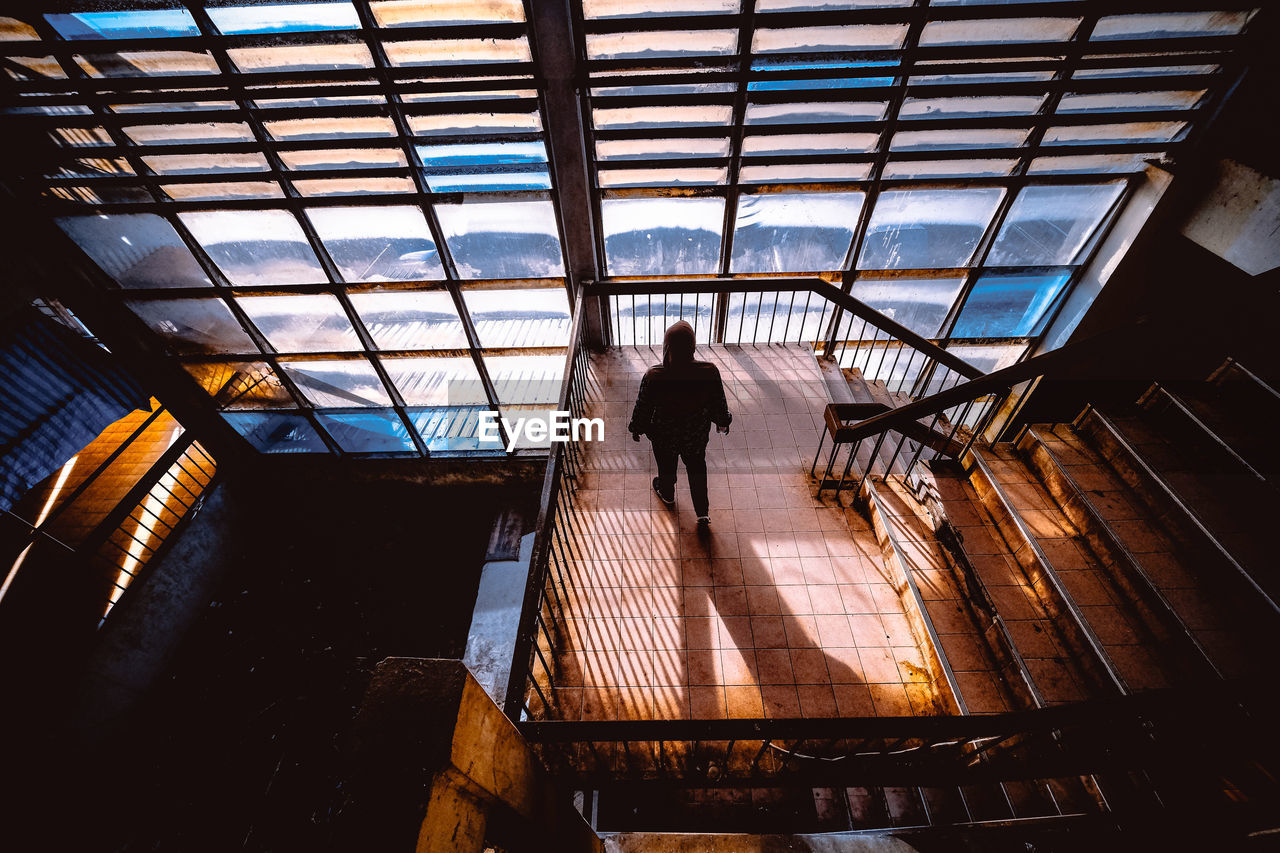 High angle view of silhouette woman on staircase