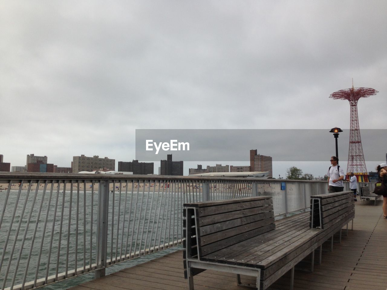 VIEW OF EMPTY PIER WITH CITY IN BACKGROUND