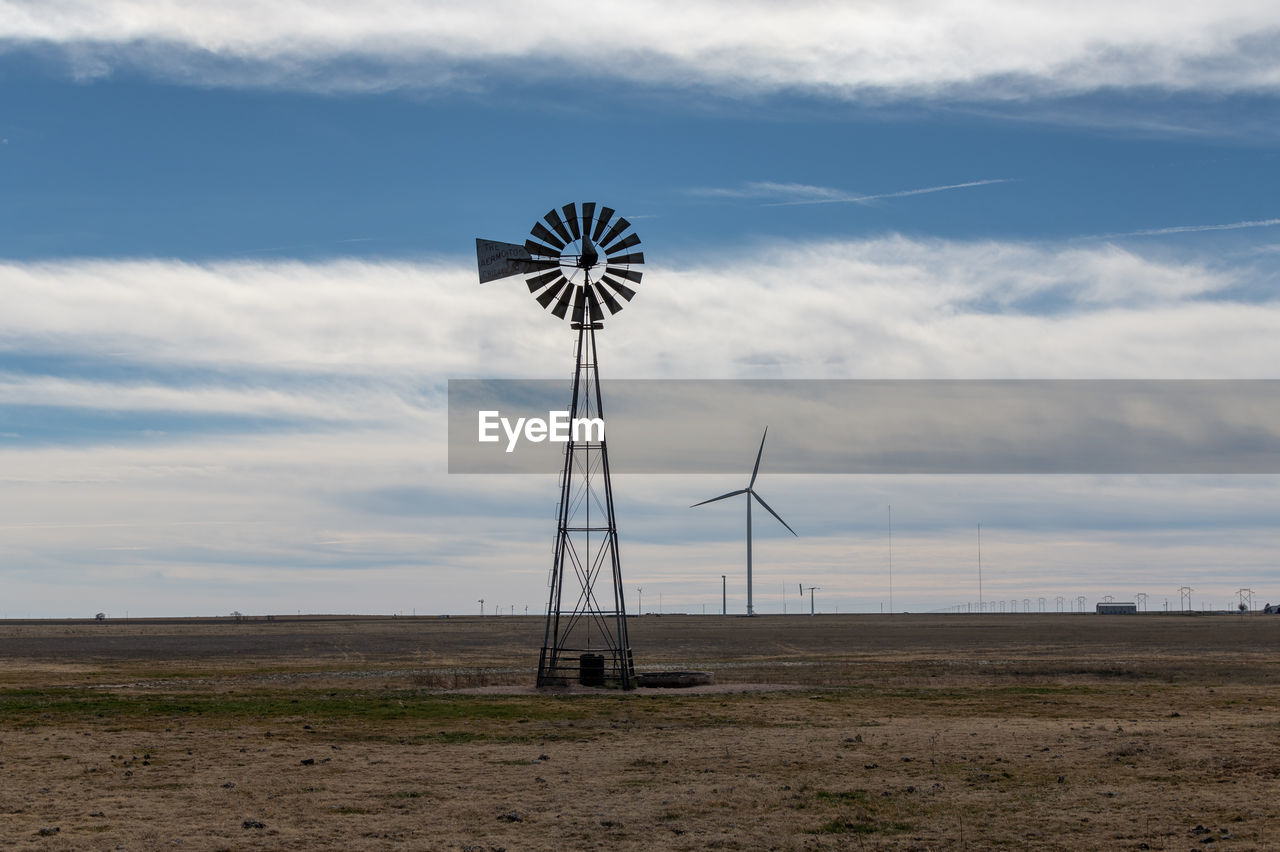 Windmill on the prairie with wind generator in the background