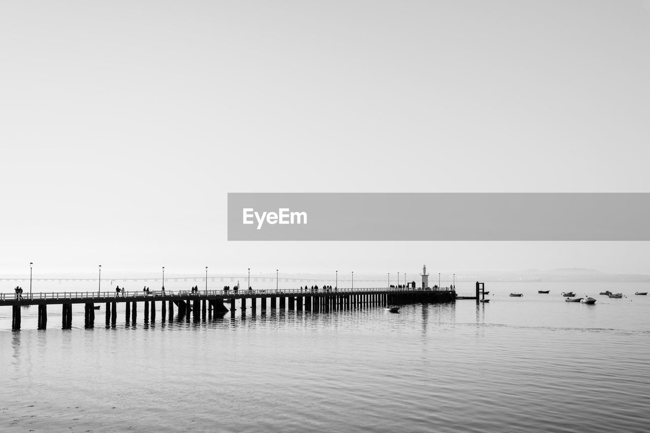 Pier on sea against clear sky