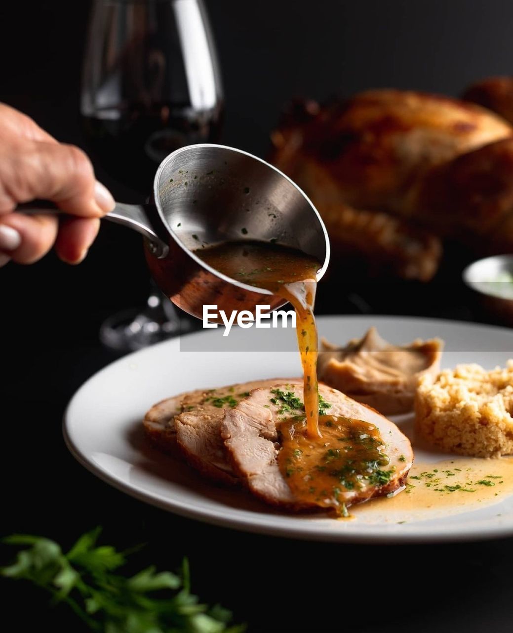 CLOSE-UP OF PERSON HAND POURING FOOD