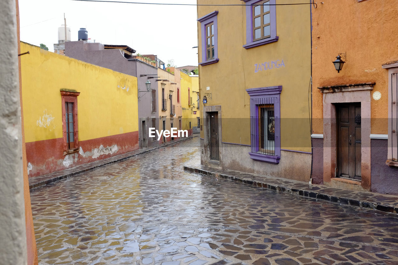 WET STREET BY BUILDINGS