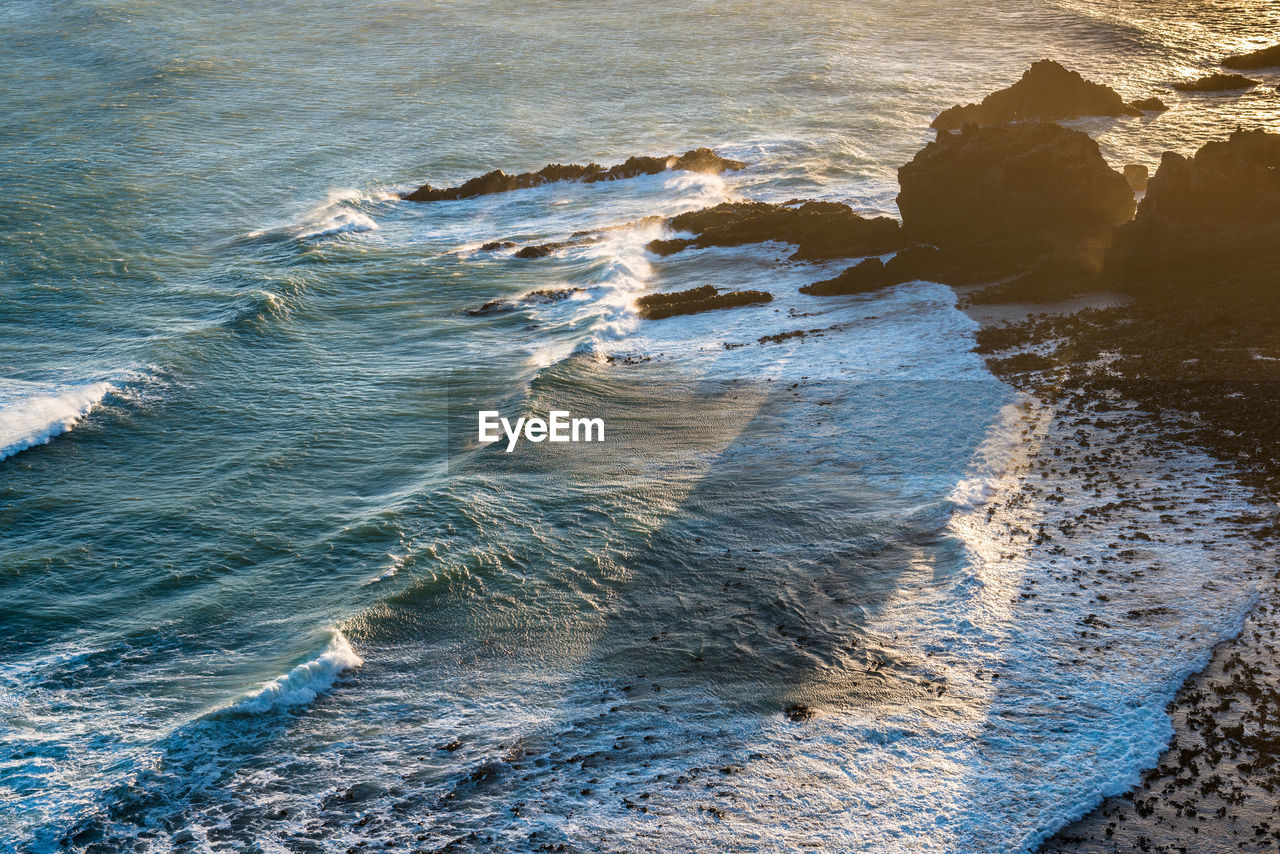 SCENIC VIEW OF ROCKS ON SEA SHORE