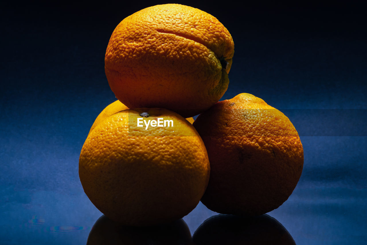 CLOSE-UP OF ORANGE FRUIT ON TABLE