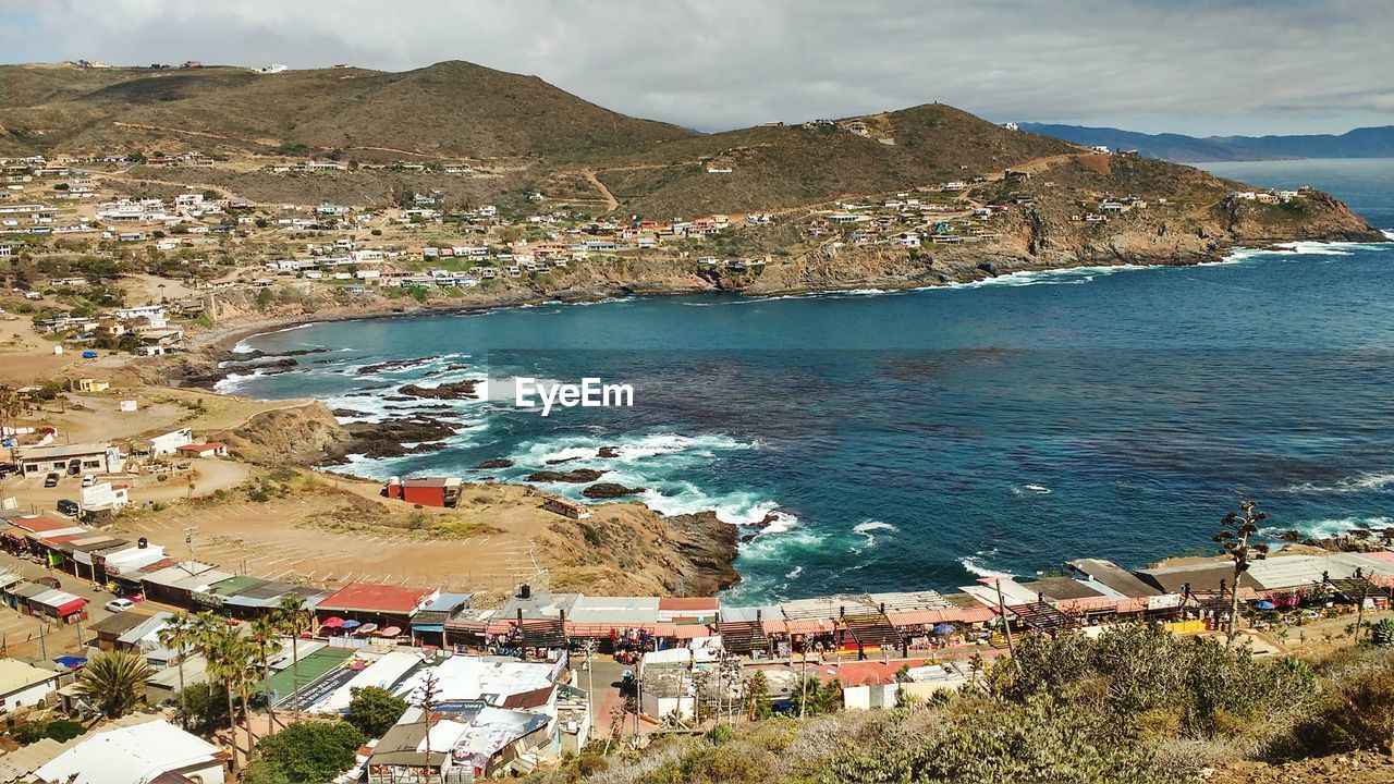 High angle view of sea by mountain