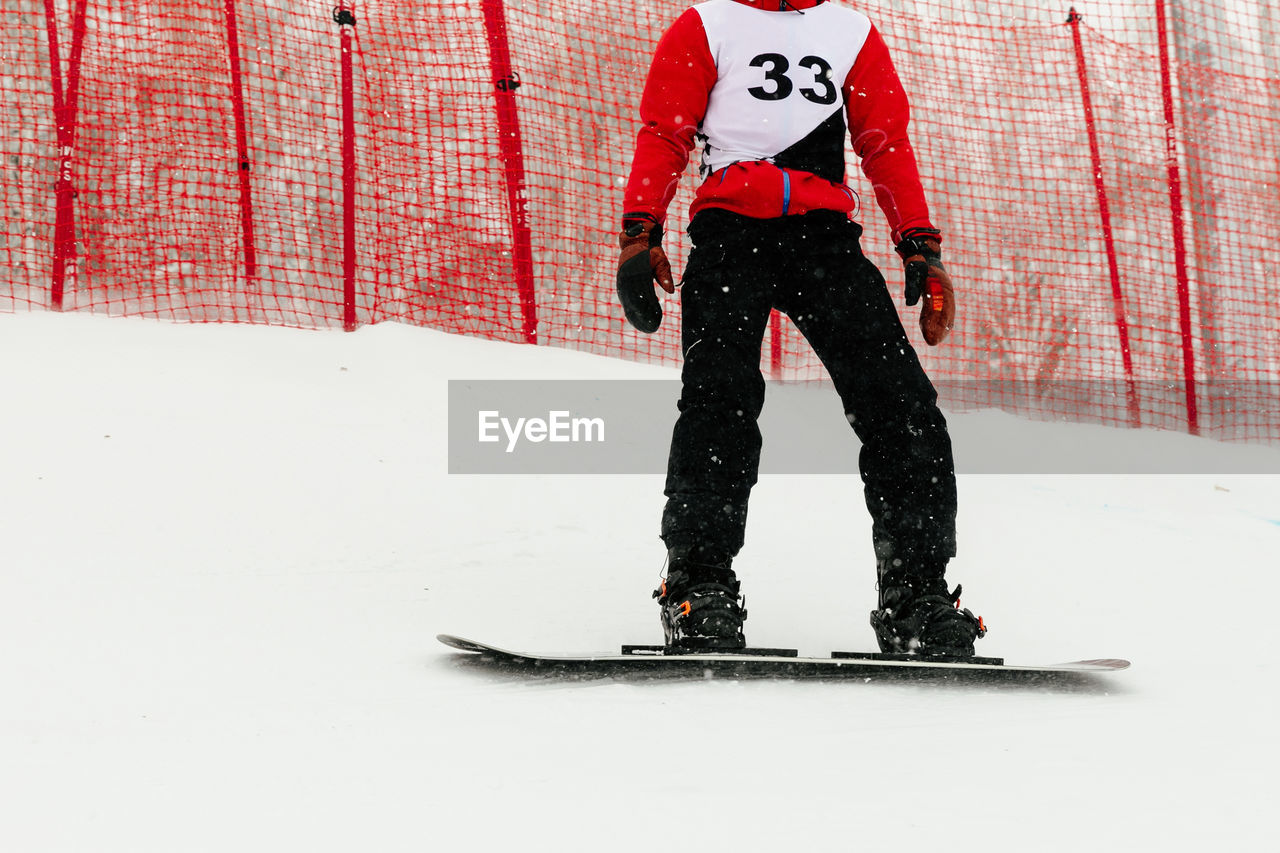 Athlete snowboarder riding on track snowboarding competition