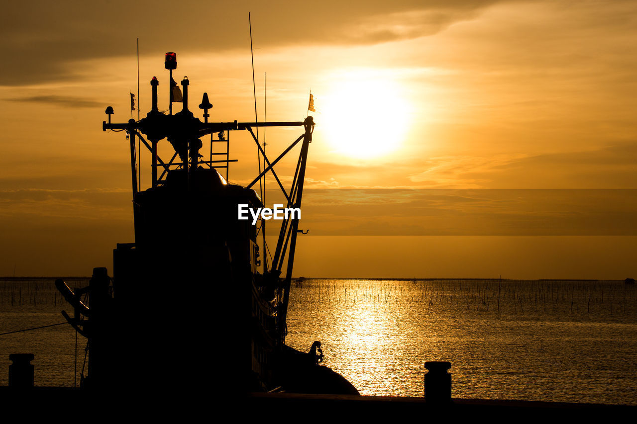 Silhouette sailboat on sea against sky during sunset