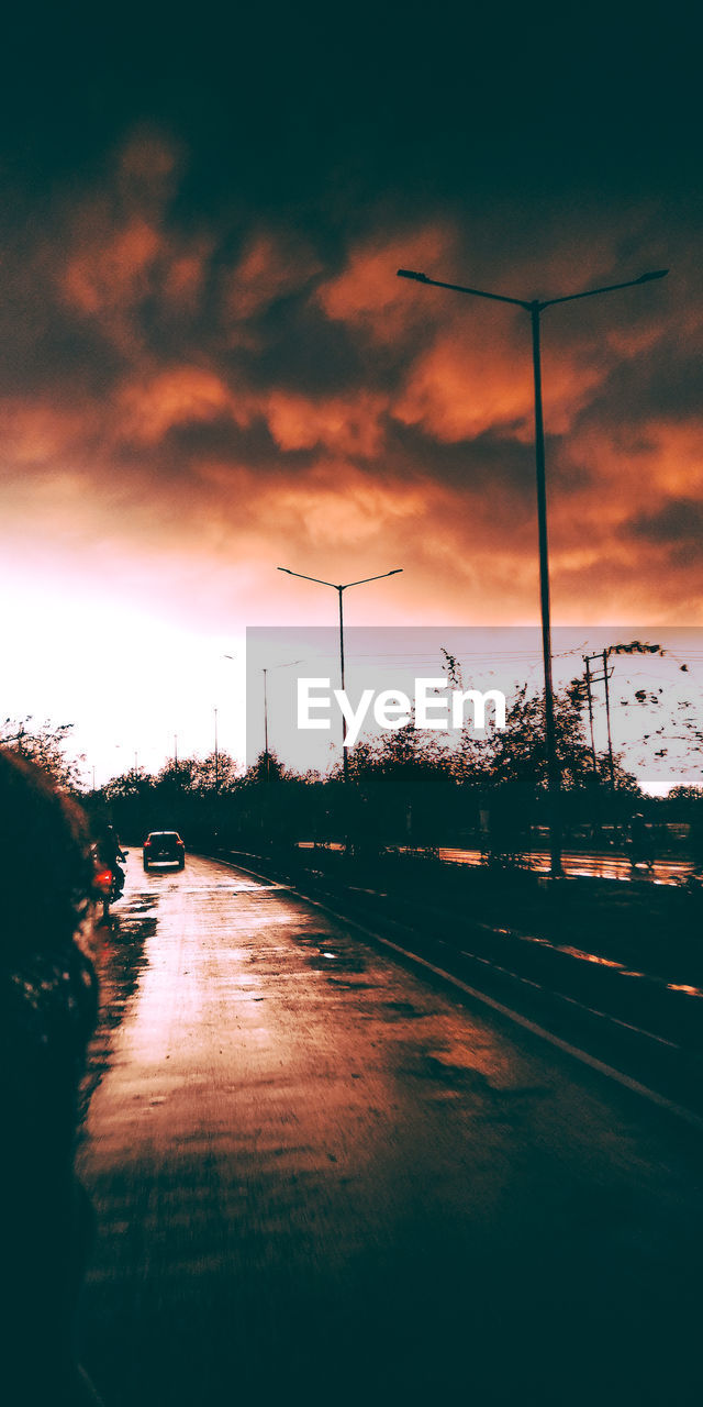 Street against sky during sunset