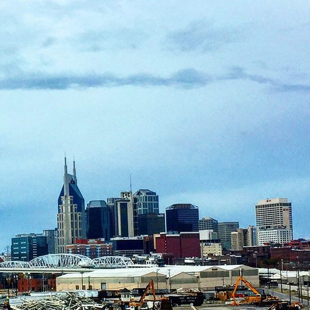 VIEW OF CITYSCAPE AGAINST CLOUDY SKY