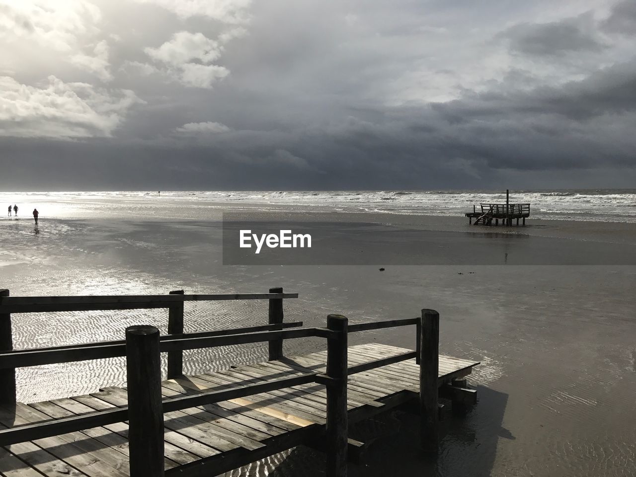 PIER ON BEACH AGAINST SKY