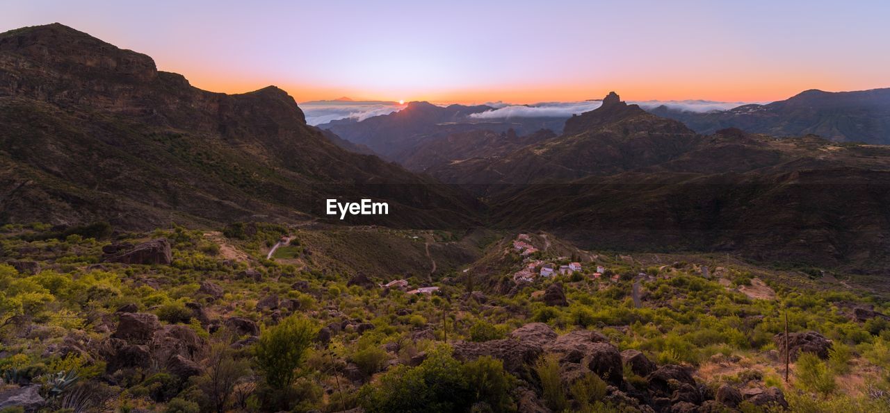 Scenic view of mountains against sky during sunset