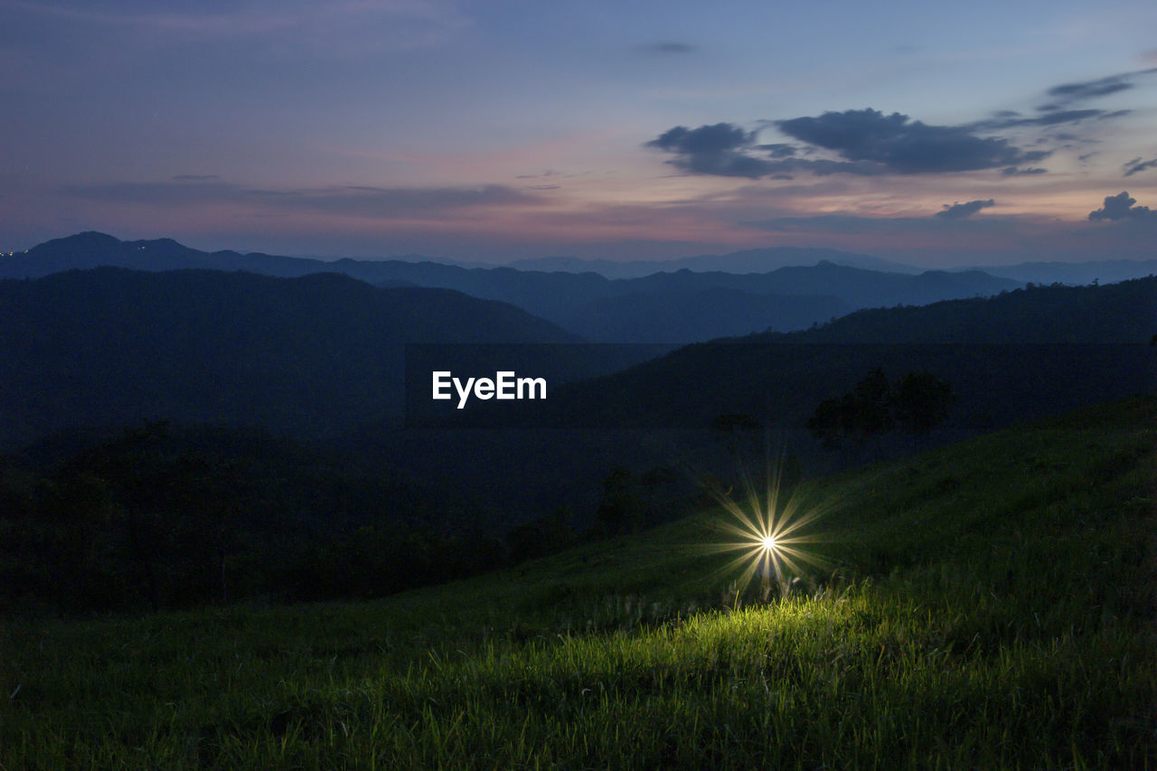 Scenic view of field against sky during sunset