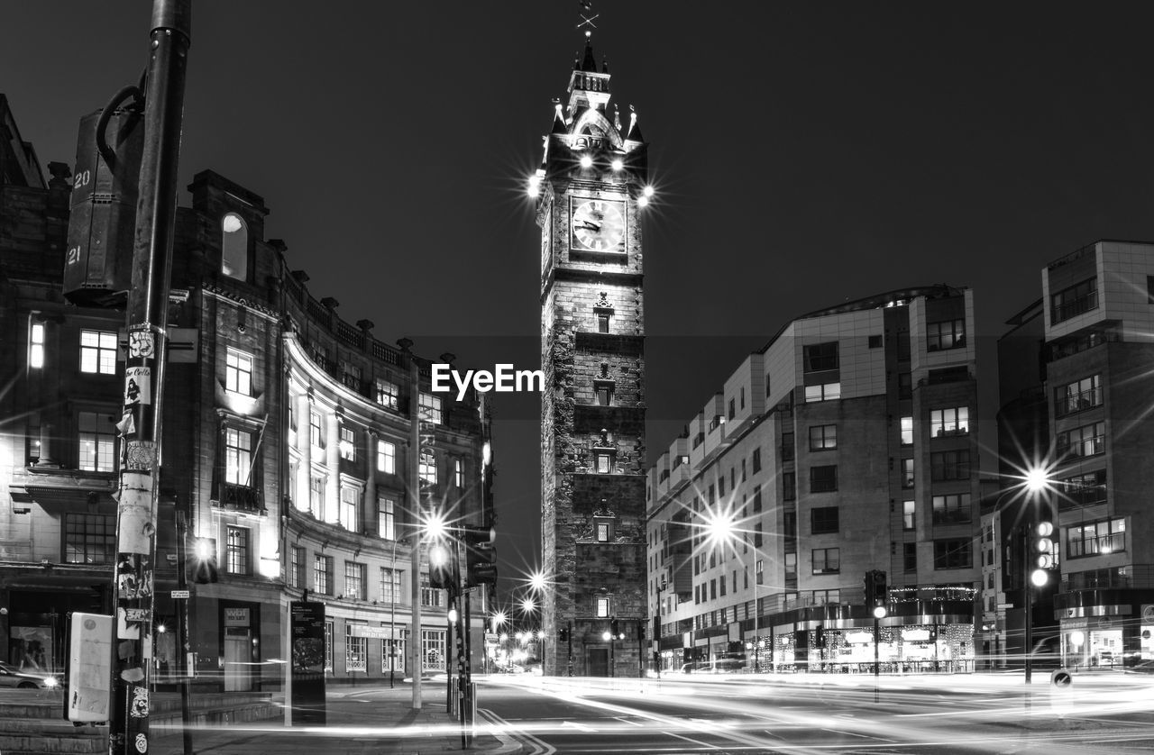 VIEW OF CITY STREET AT NIGHT