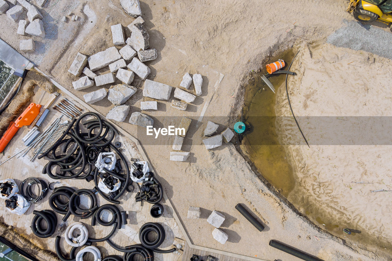 HIGH ANGLE VIEW OF GRAFFITI ON WET SAND