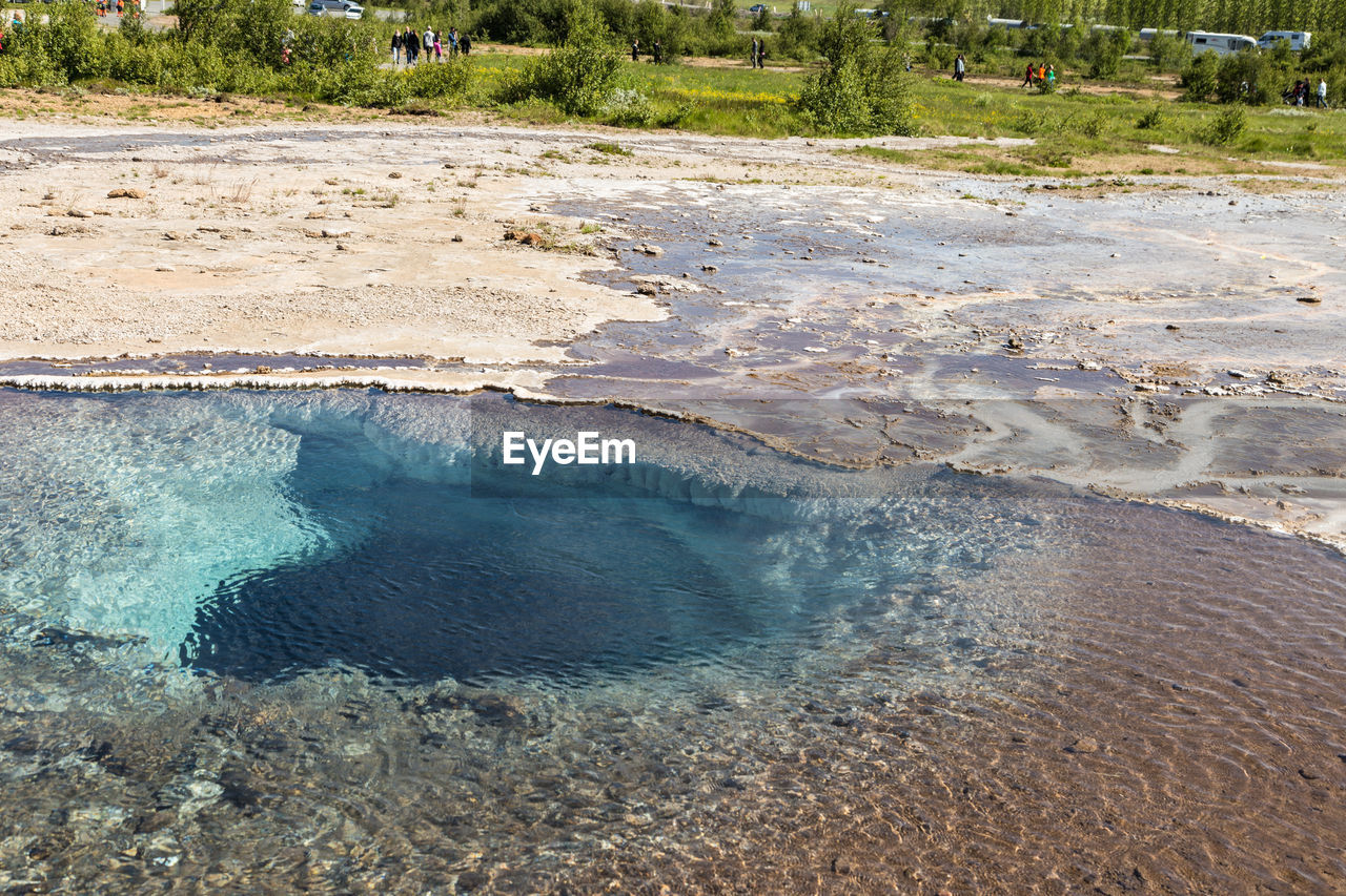 VIEW OF LANDSCAPE WITH WATER IN BACKGROUND