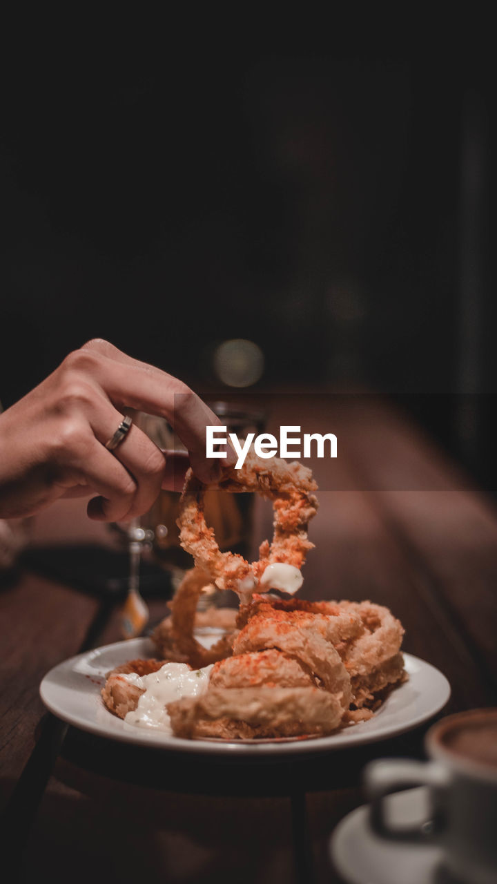 Close-up of person holding ice cream on table