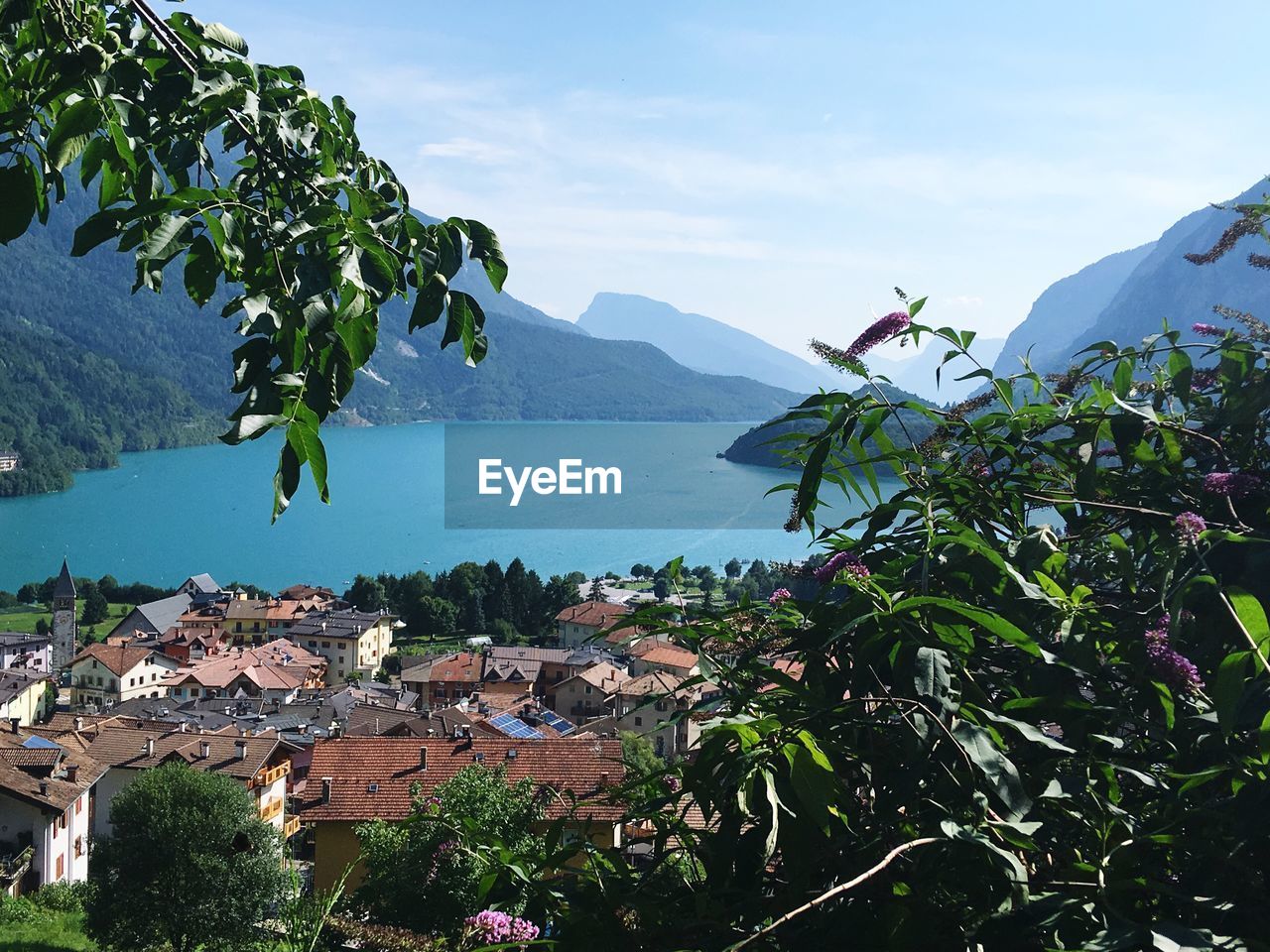 Scenic view of sea by city against sky