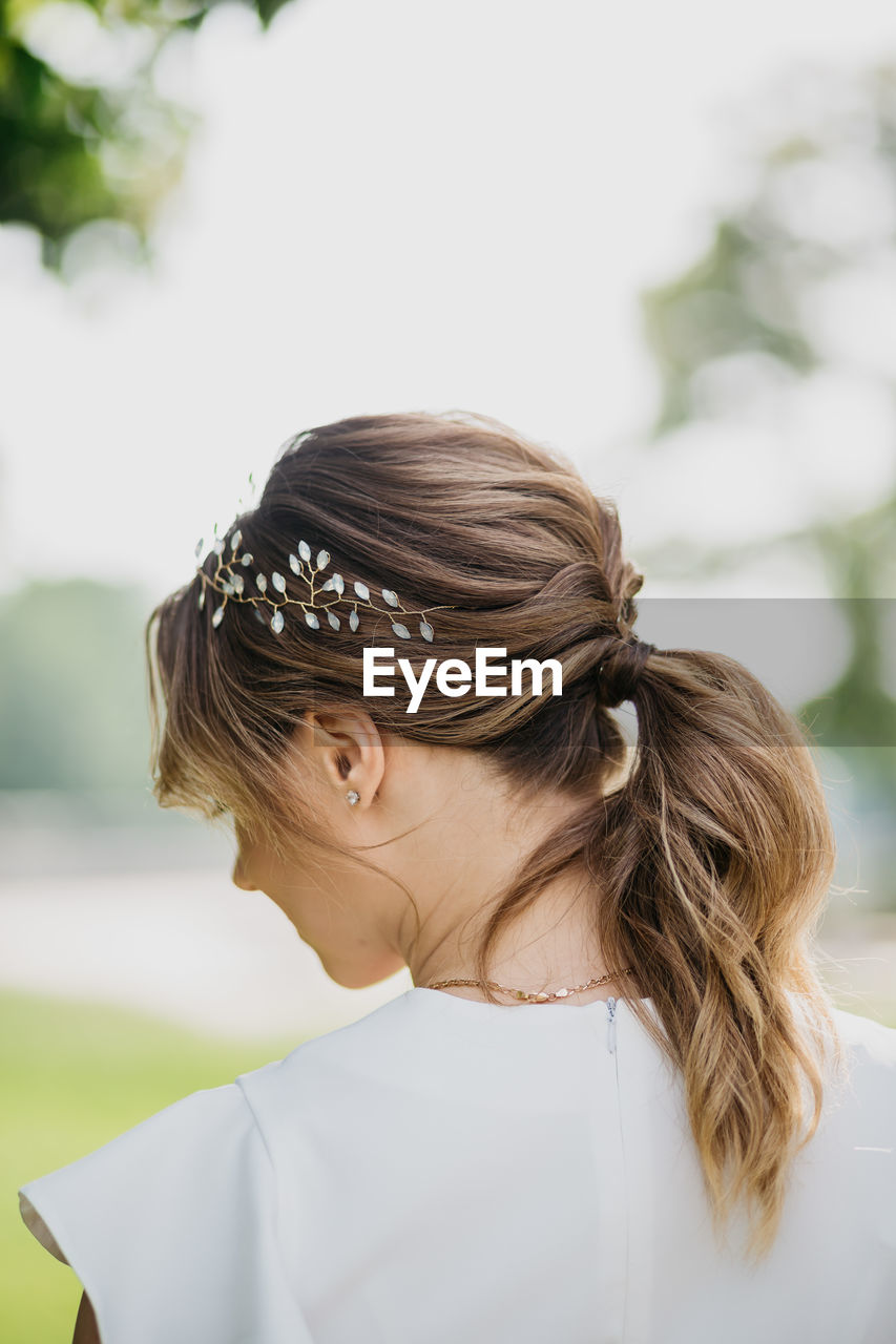 Rear view of woman wearing headwear