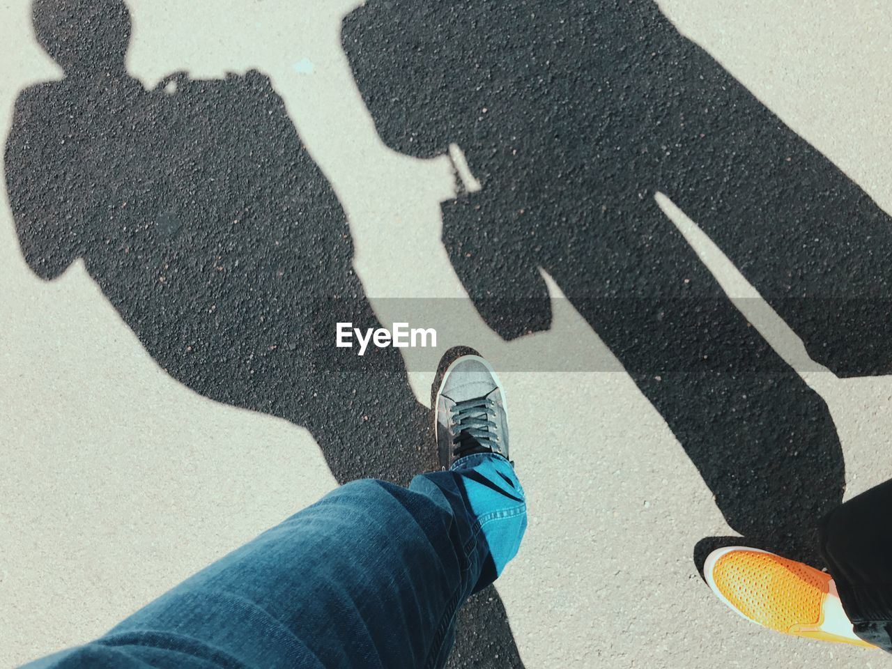 Low section of people standing on road