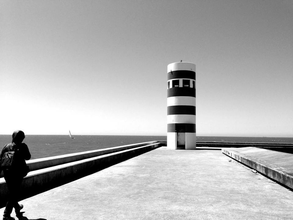 LIGHTHOUSE ON BEACH AGAINST CLEAR SKY