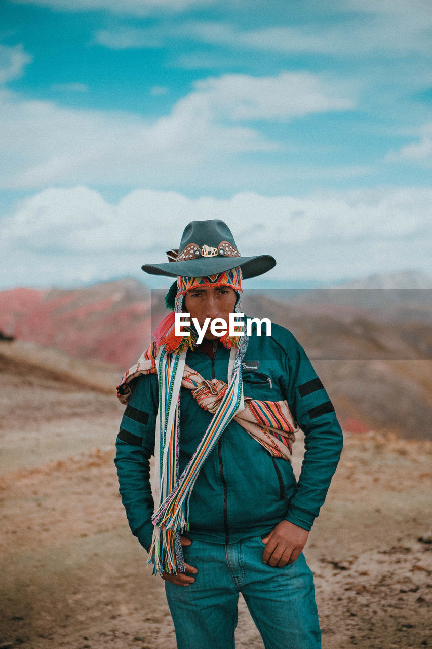 PORTRAIT OF MAN STANDING ON LAND