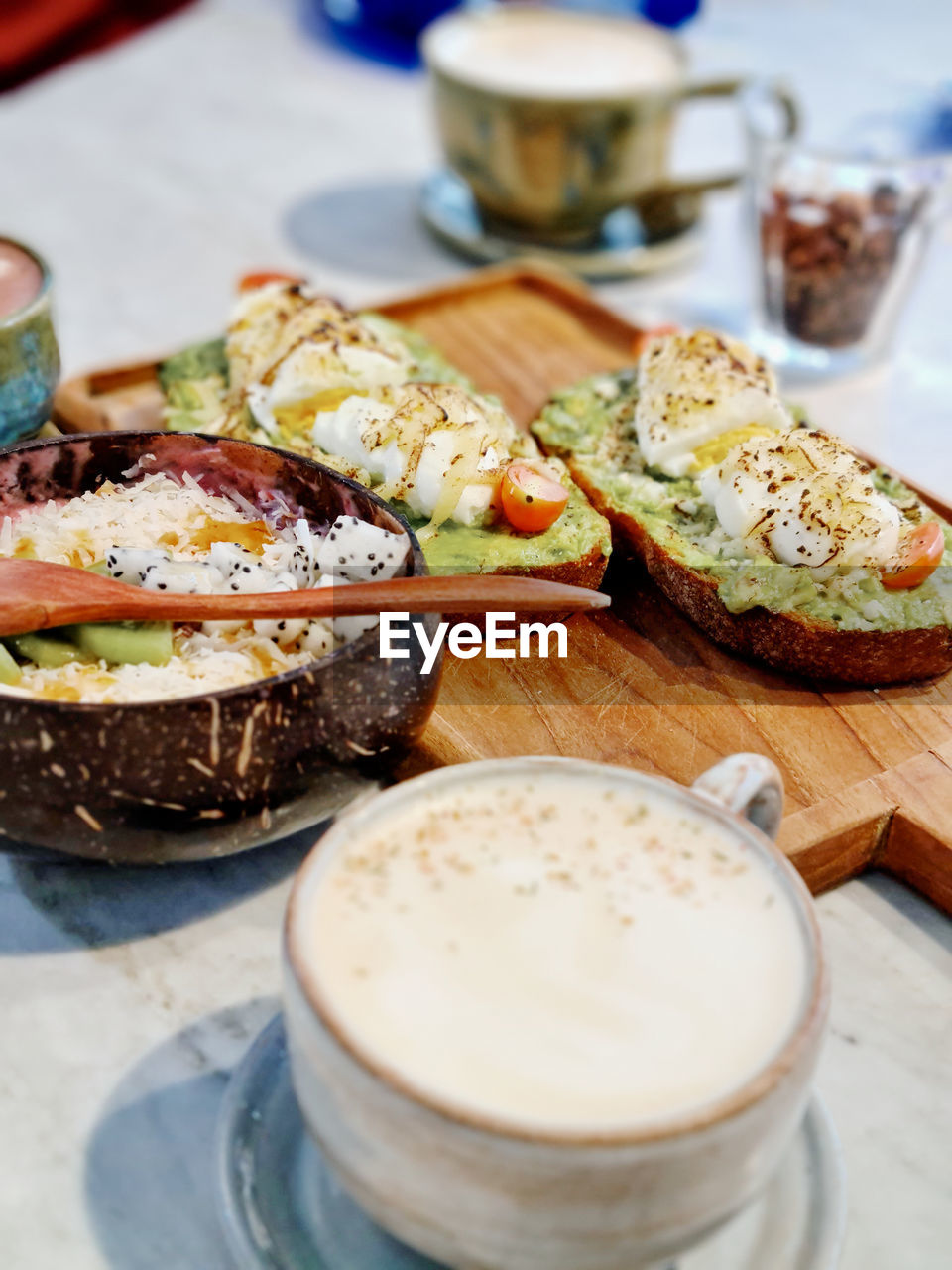 High angle view of avocado toast and coffee breakfast on table