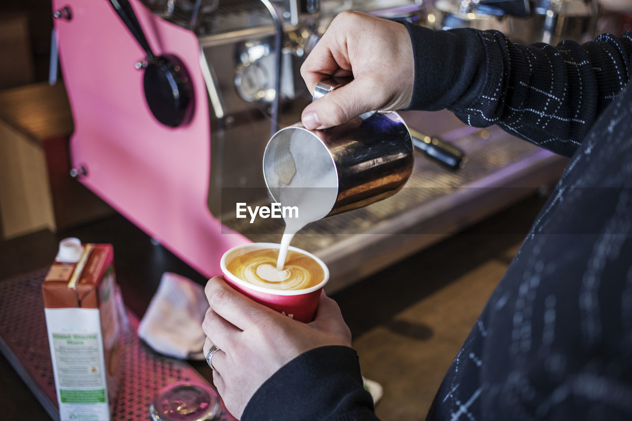 Cropped image of woman making coffee