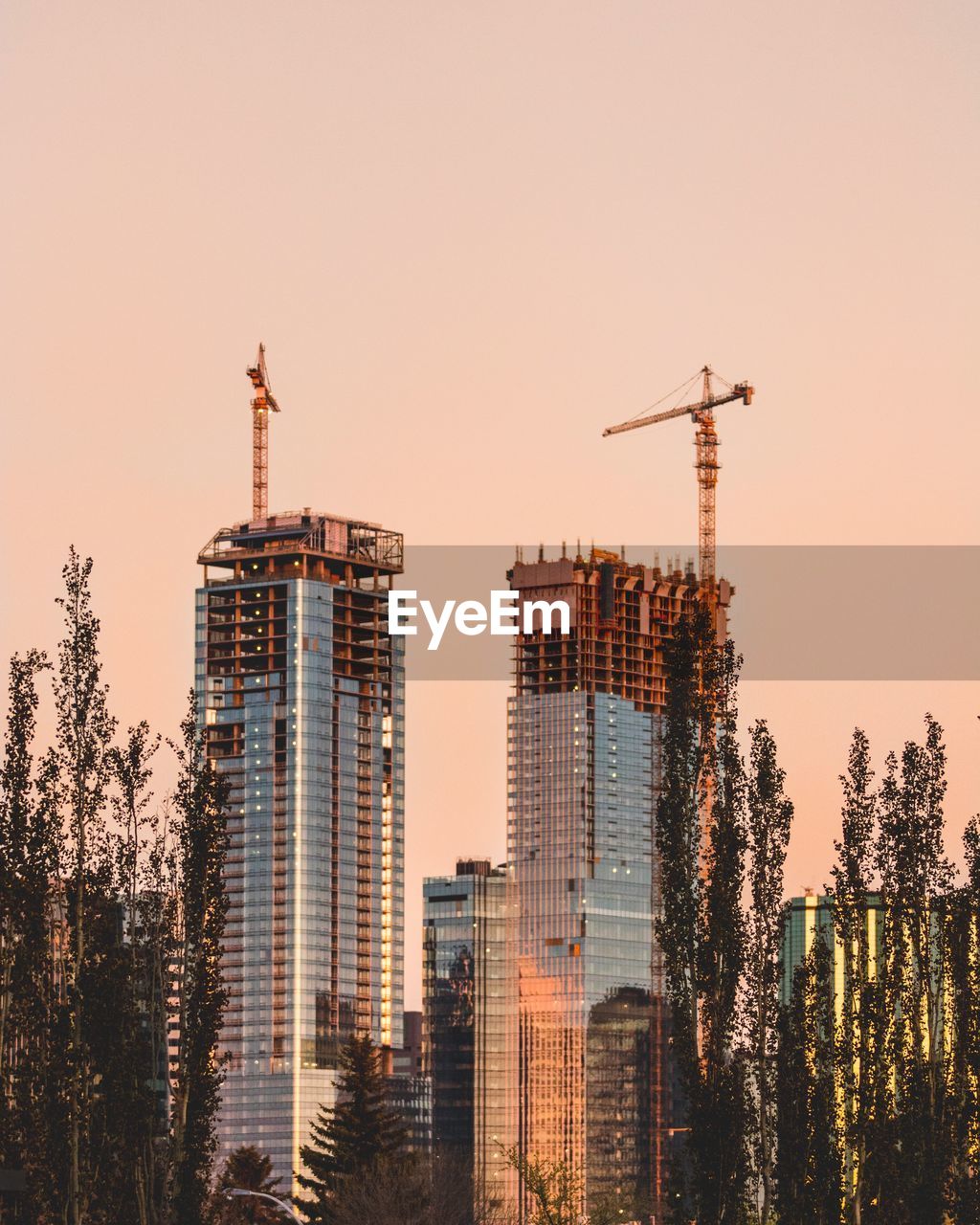 MODERN BUILDINGS AGAINST SKY AT SUNSET