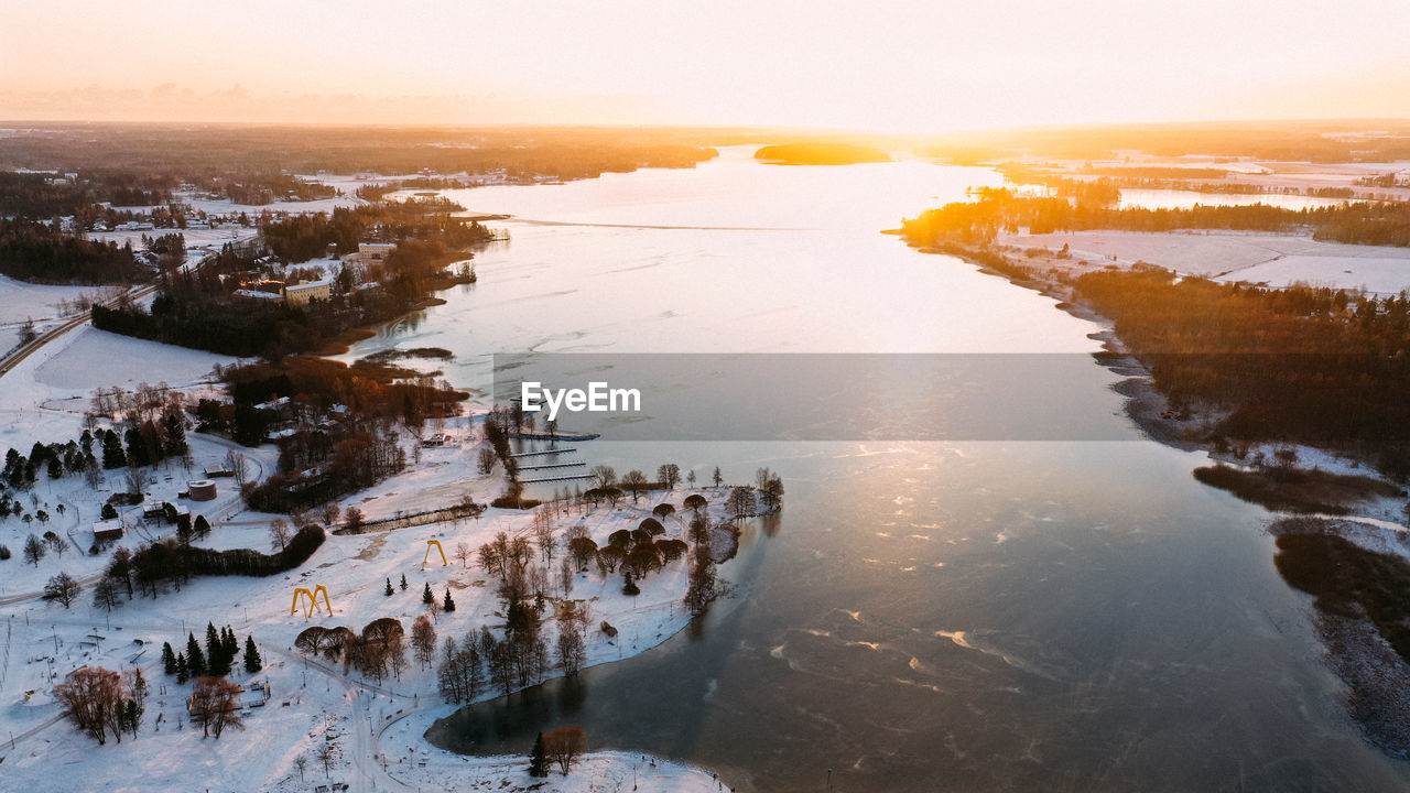 High angle view of frozen lake during sunset