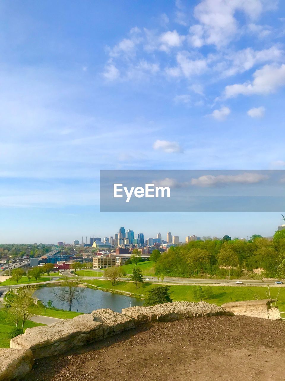 Scenic view of field by buildings against sky