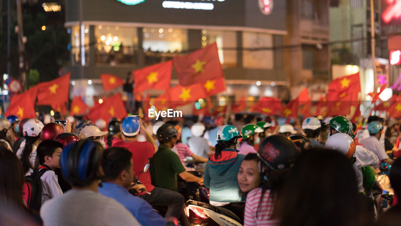 GROUP OF PEOPLE ON STREET IN CITY