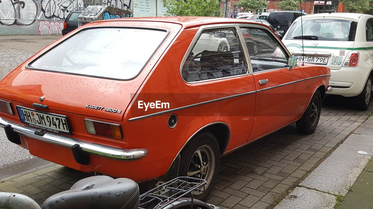 transportation, stationary, land vehicle, mode of transport, car, day, outdoors, red, no people