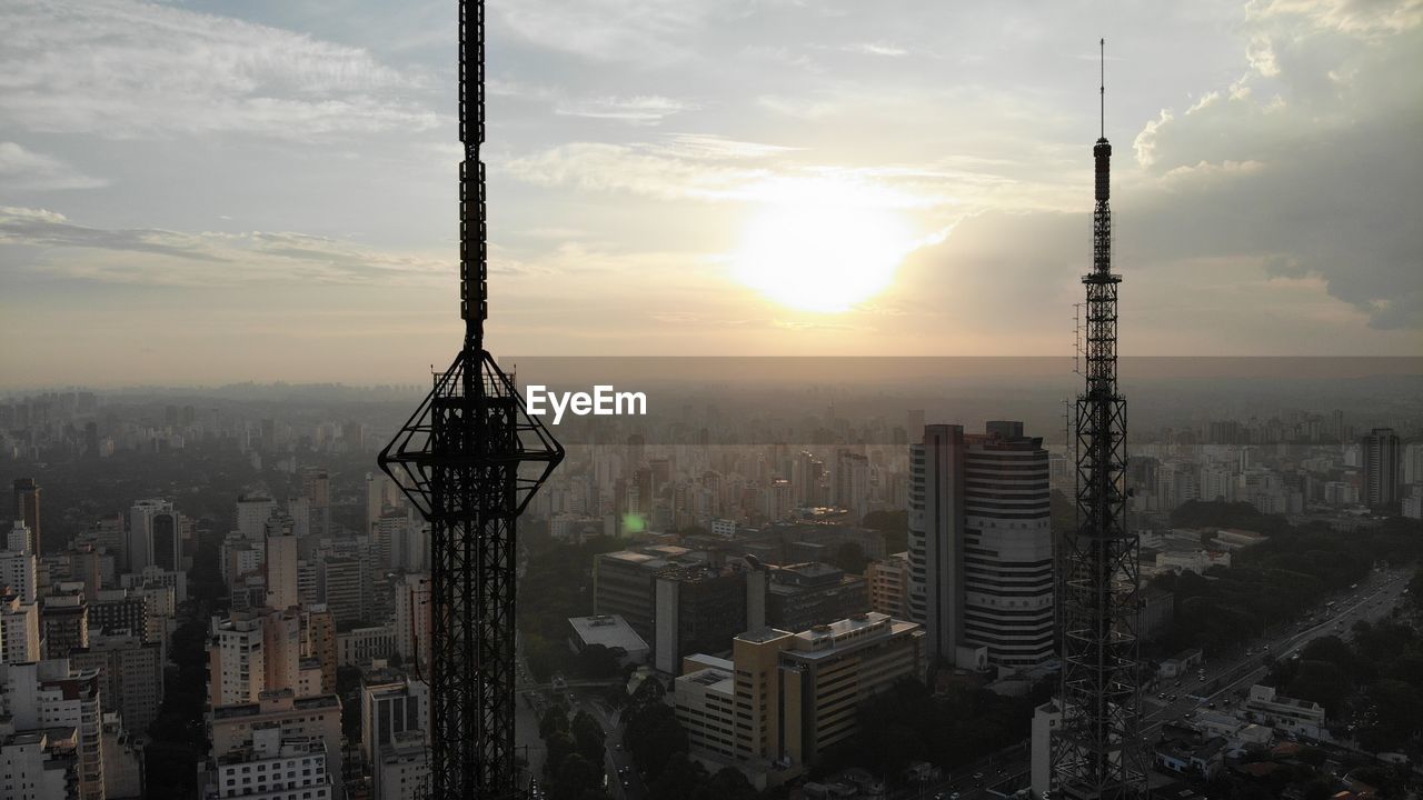 MODERN BUILDINGS AGAINST SKY AT SUNSET