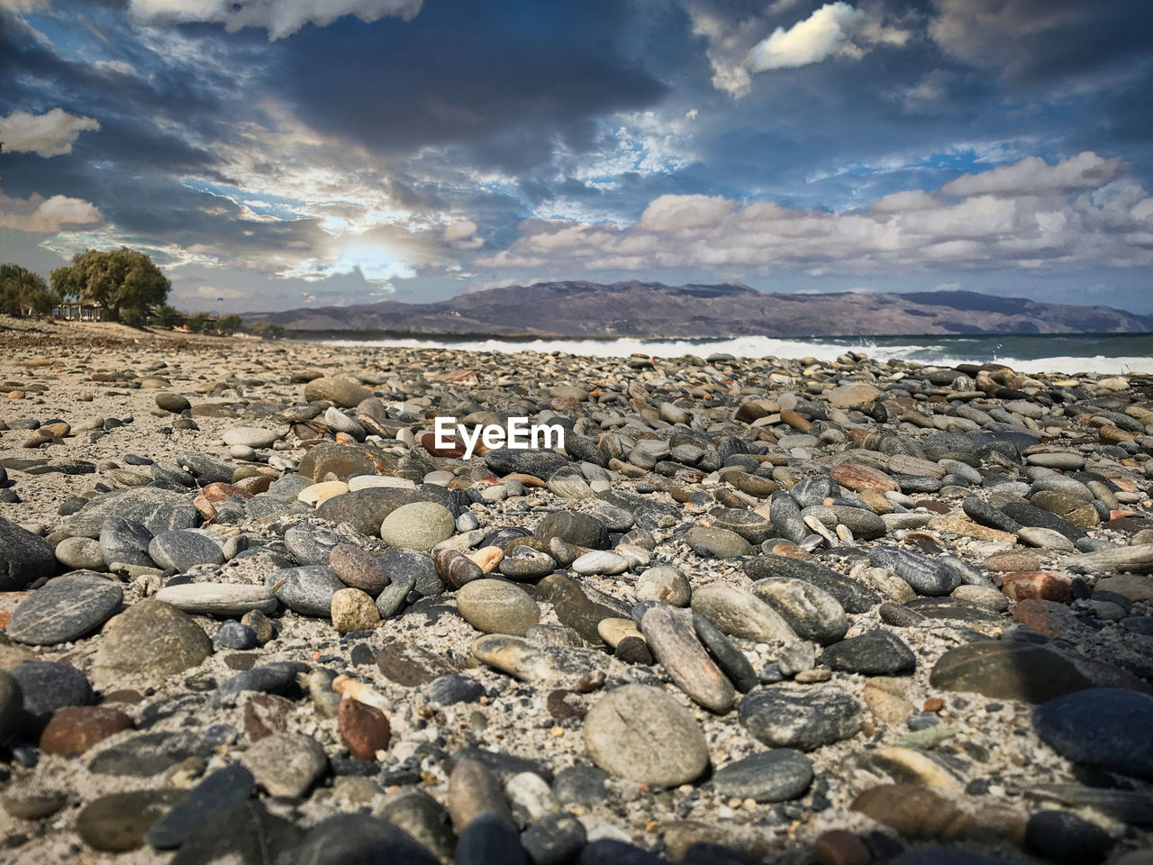SURFACE LEVEL OF ROCKS ON SHORE AGAINST SKY