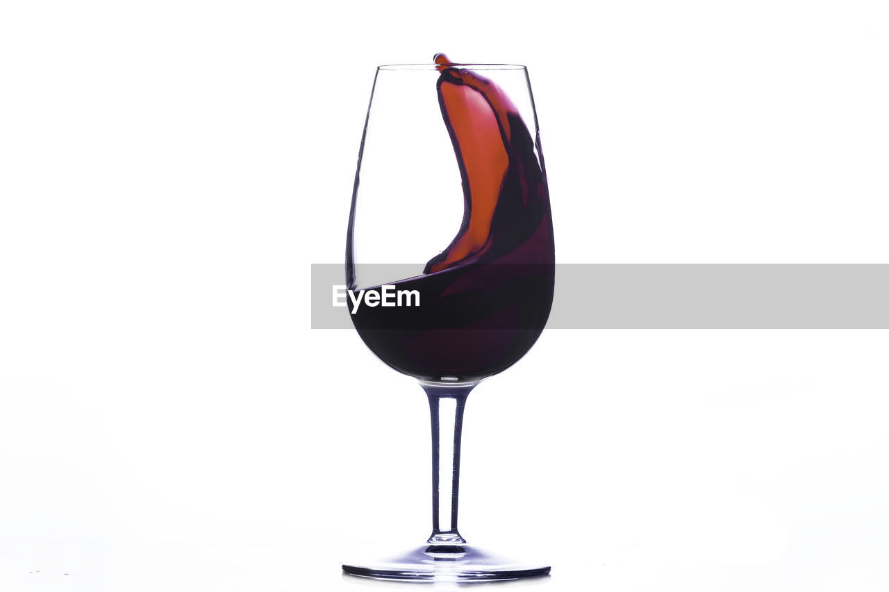 Red wine wave in a glass isolated on white background